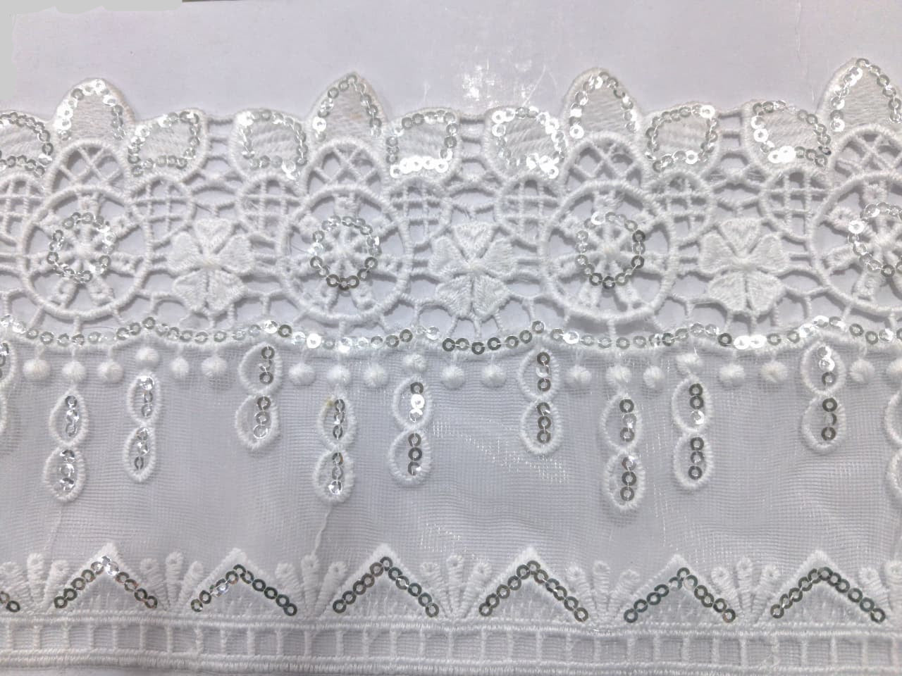 3D Fancy Sequence Milky White Lace. Lace sixe is approximately 4.25-4.5 inches. Lace is available as per yard.