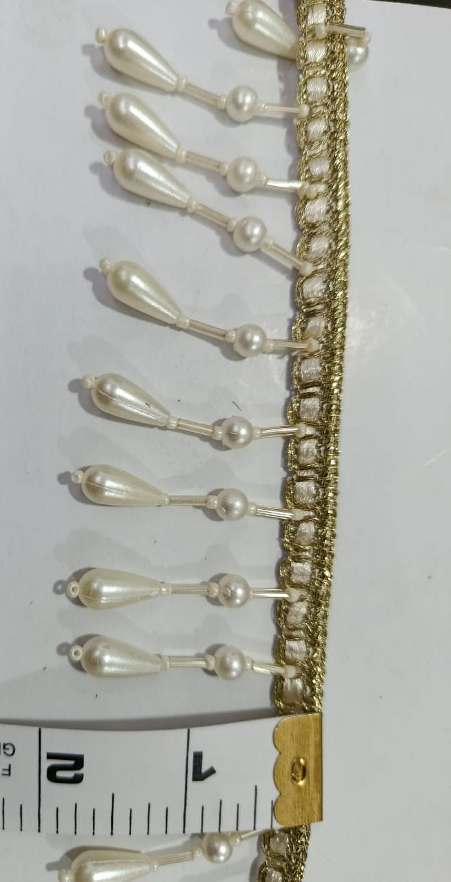 Elegant Pearl Drop Lace. Lace size is approximatel 1.5 Inches. Lace is available as per yard.