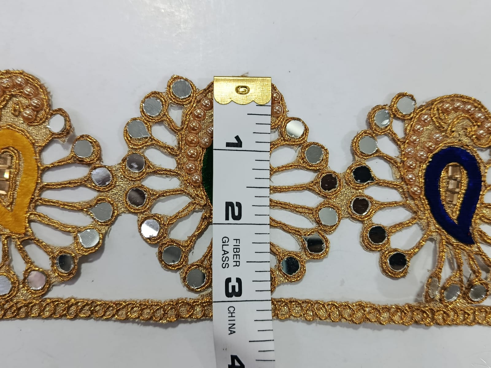 Golden Fancy Lace with Mirror Work with Mix Colours. Lace size is approximately 3-3.25 Inches. Lace is available as per yard.