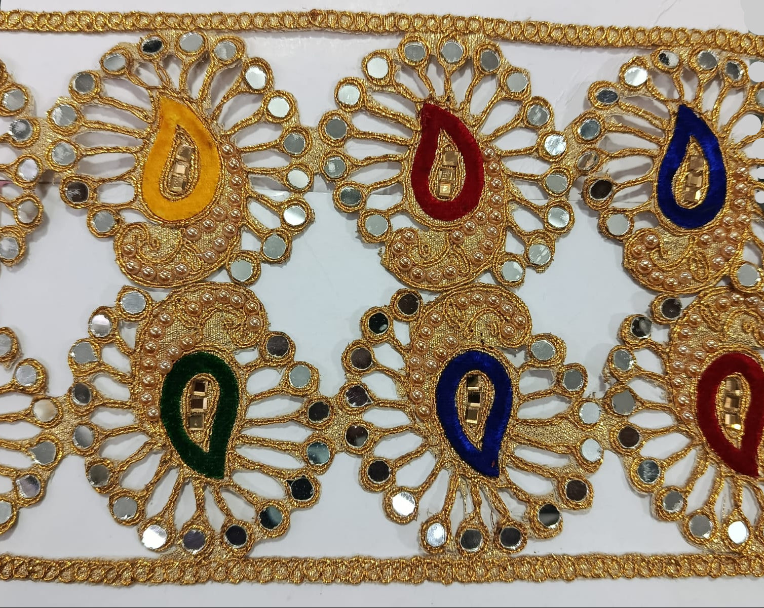 Golden Fancy Lace with Mirror Work with Mix Colours. Lace size is approximately 3-3.25 Inches. Lace is available as per yard.